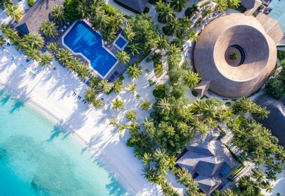 Ariel view of white sanded beach and luxury hotel